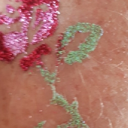 Putting glitter tattoos in front of everyone.